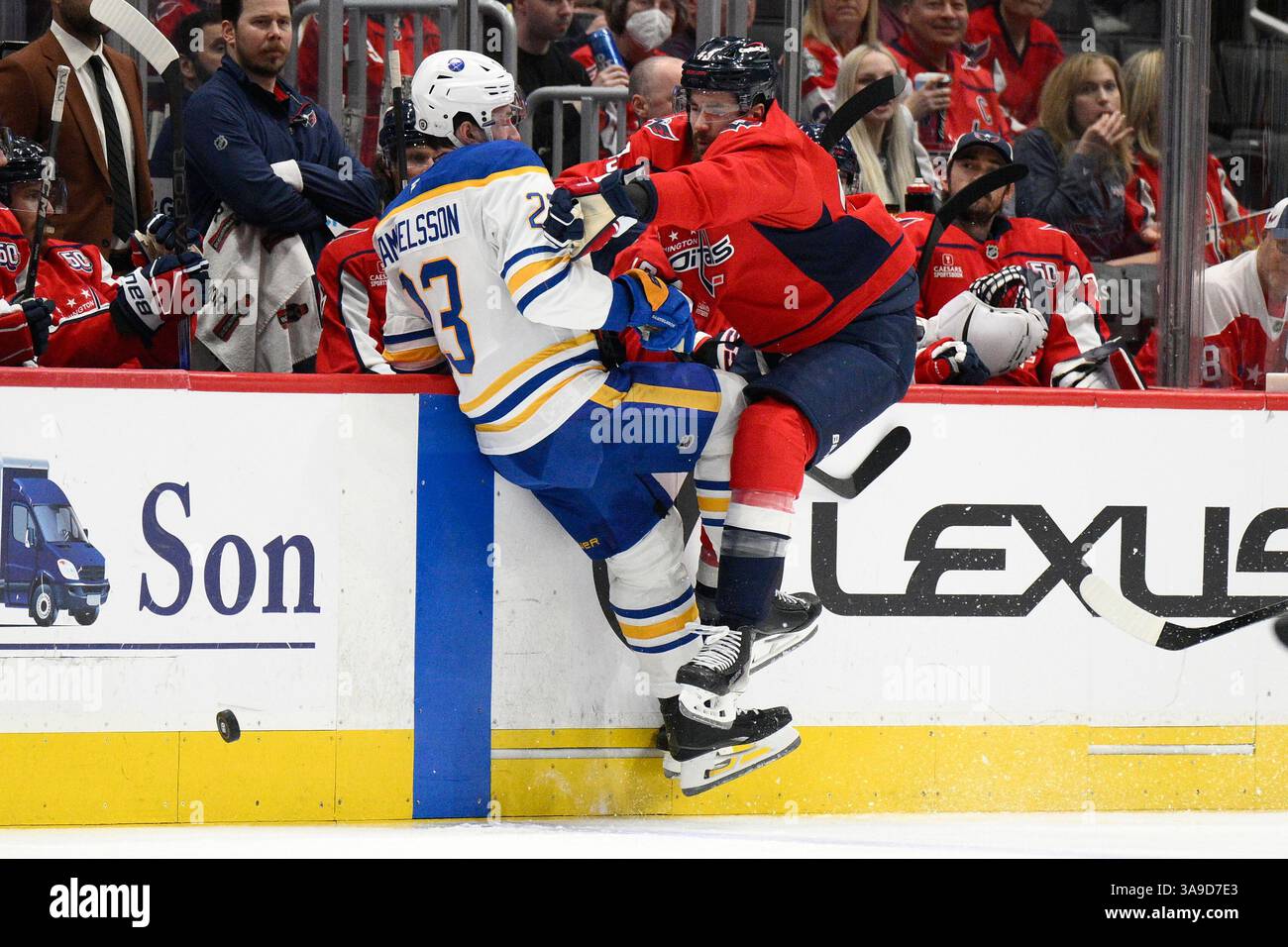 Washington Capitals right wing Tom Wilson, right, hits Buffalo Sabres ...