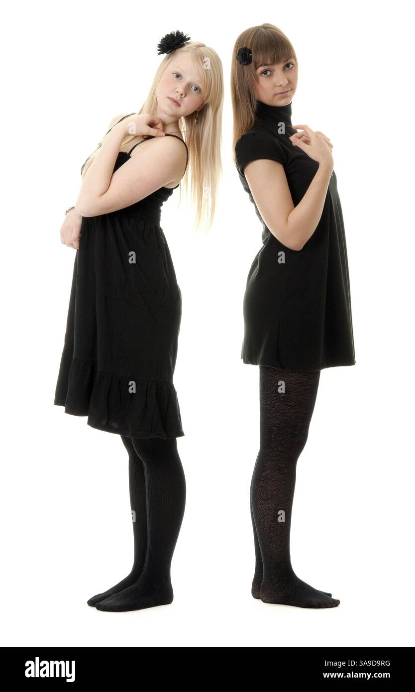 Two girls in black dresses with a white background Stock Photo - Alamy