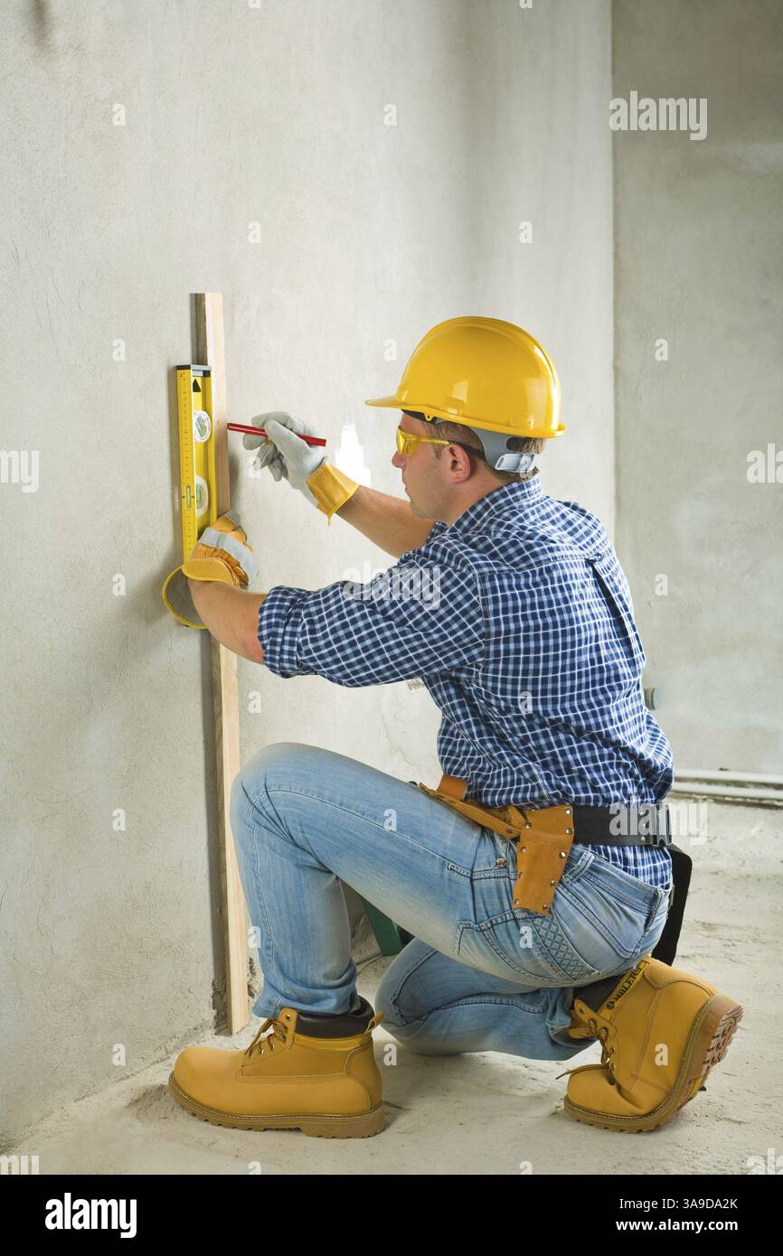 Builder at concrette wall Stock Photo