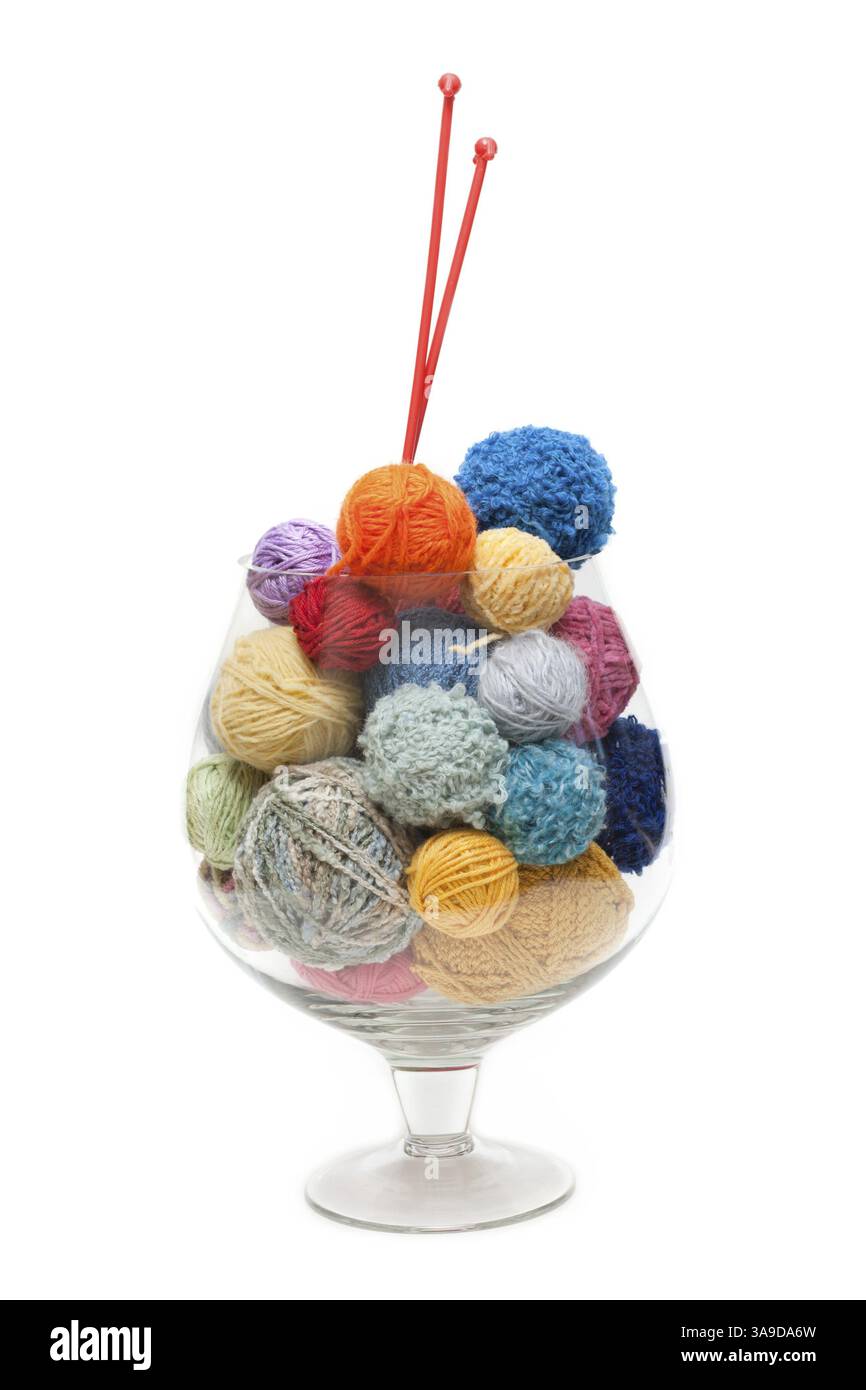 Glass with ball of the threads and spokes for knitting Stock Photo - Alamy