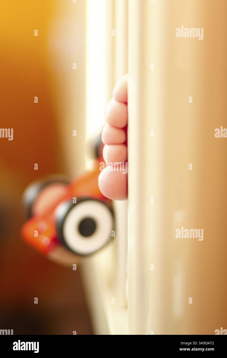 Baby feet in the playpen. Close up Stock Photo