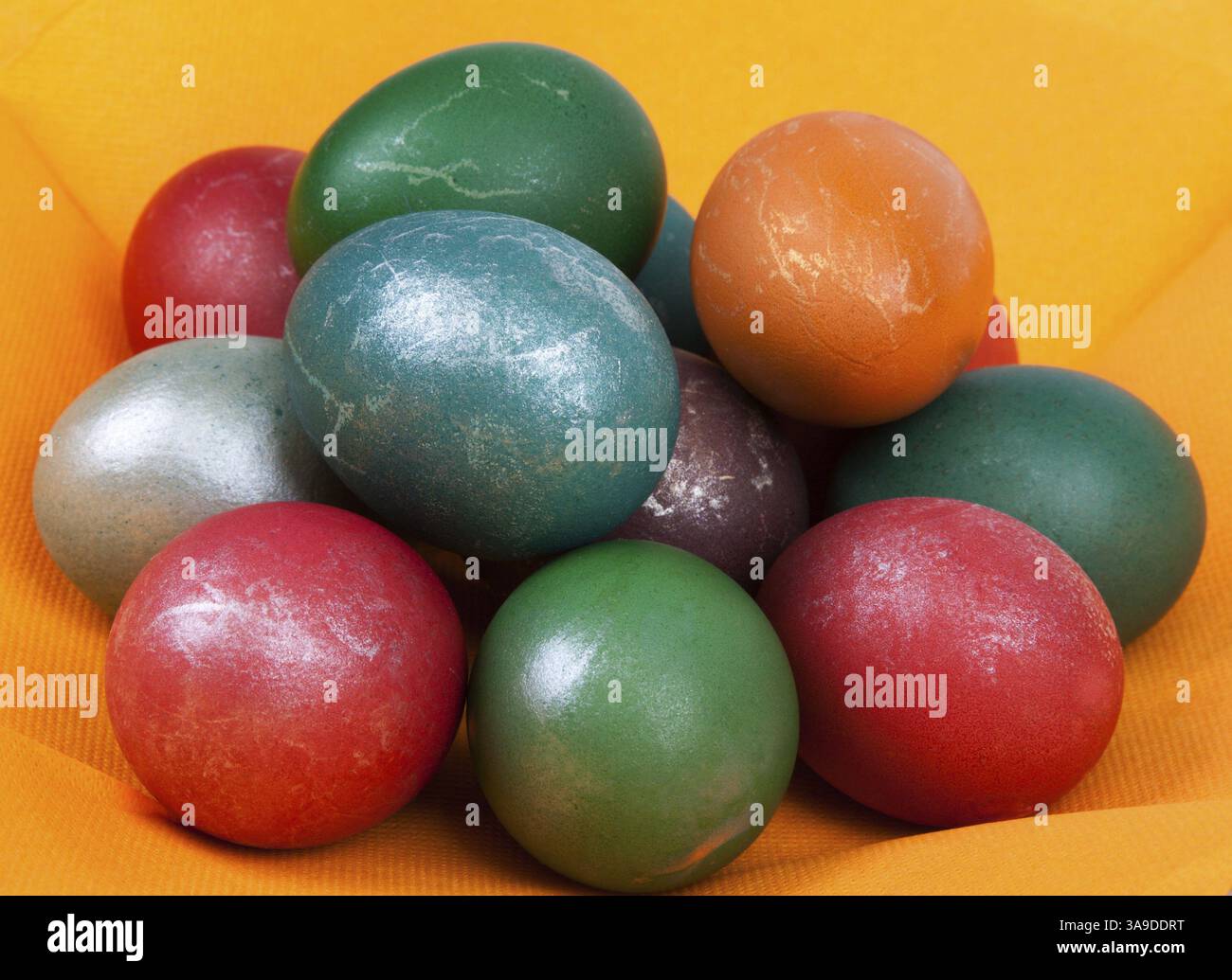 Easter dyed egg put by heap on orange napkin Stock Photo
