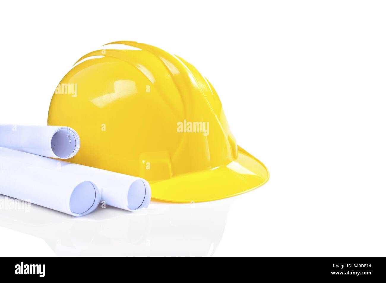 Yellow helmet with blueprints isolated Stock Photo - Alamy