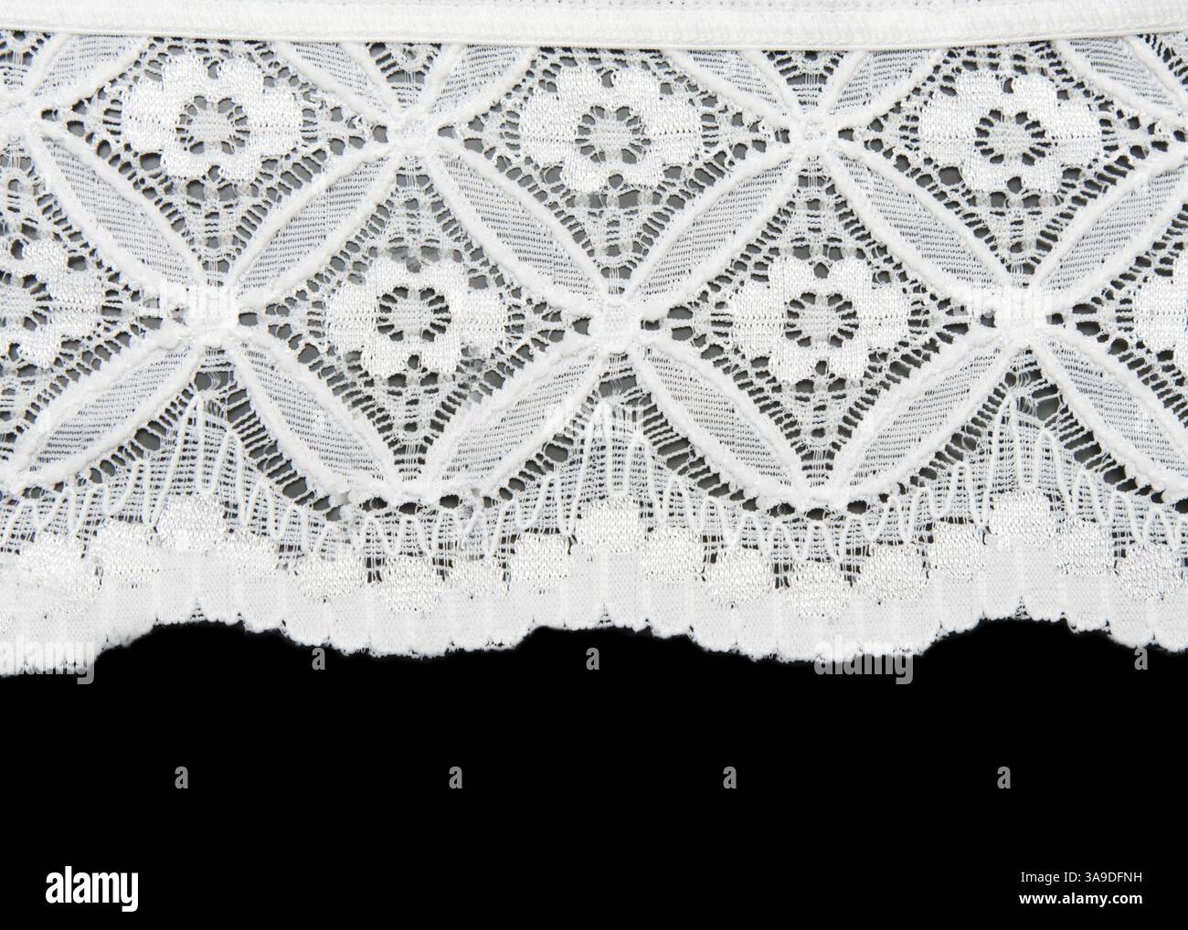 White lace with pattern in the manner of flower on black background Stock Photo