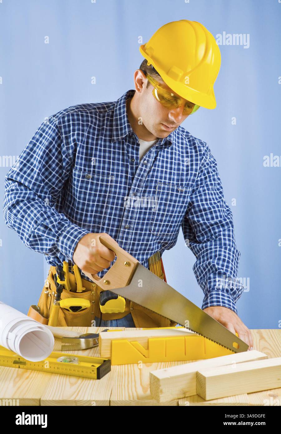 Men cutting plank Stock Photo