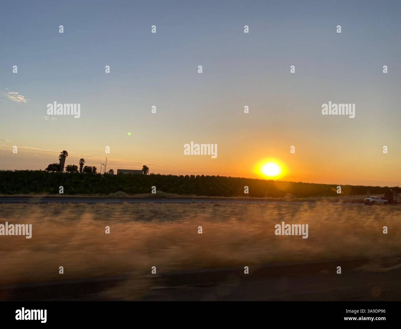 traveling on interstate 101 heading to los angeles california highway landscape with crops farm animals old buildings, sun rising over the valleys - Smartphone Captured Stock Image