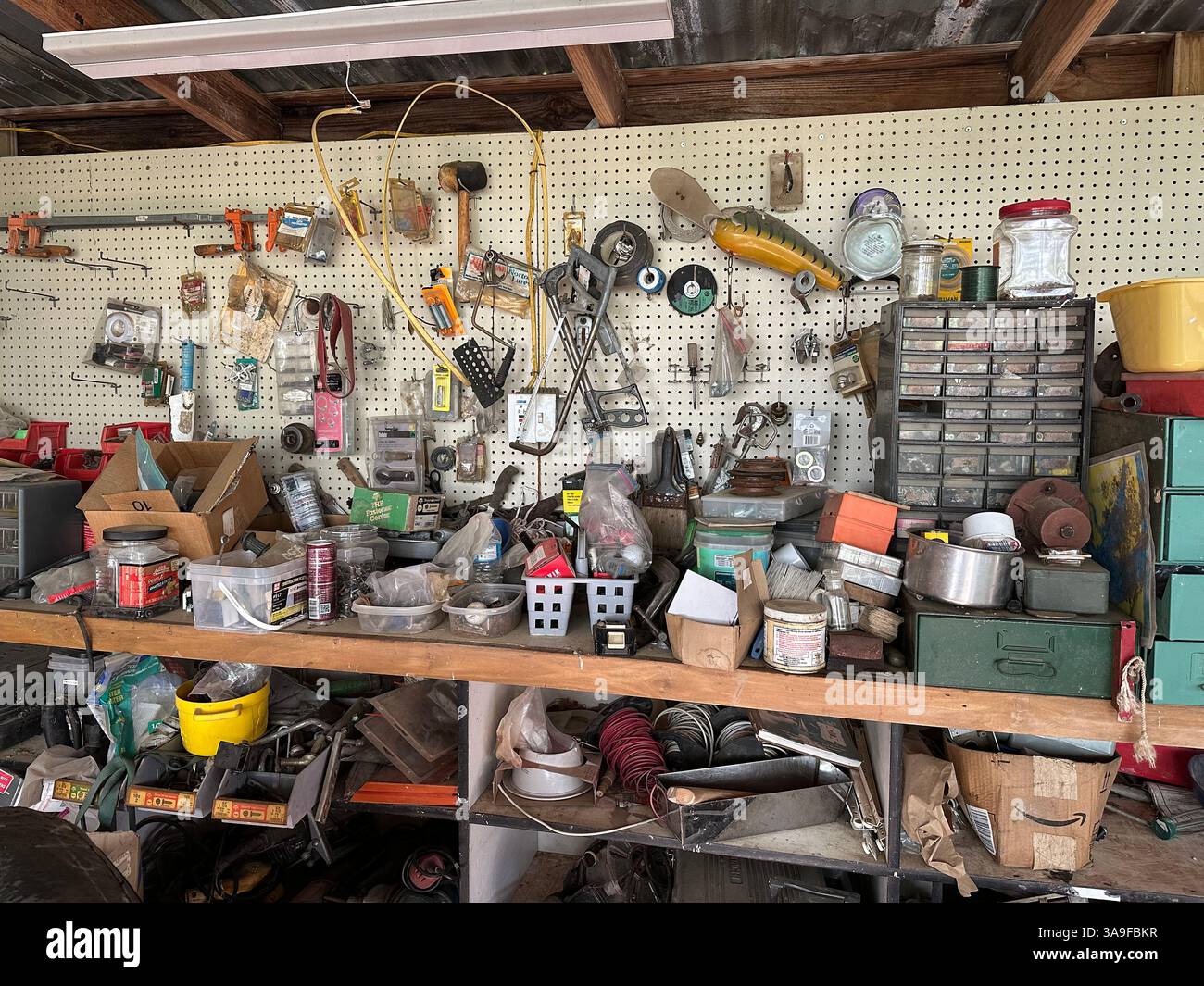 A bustling, albeit cluttered, workshop brimming with tools, hardware, and DIY essentials. - Smartphone Captured Stock Image