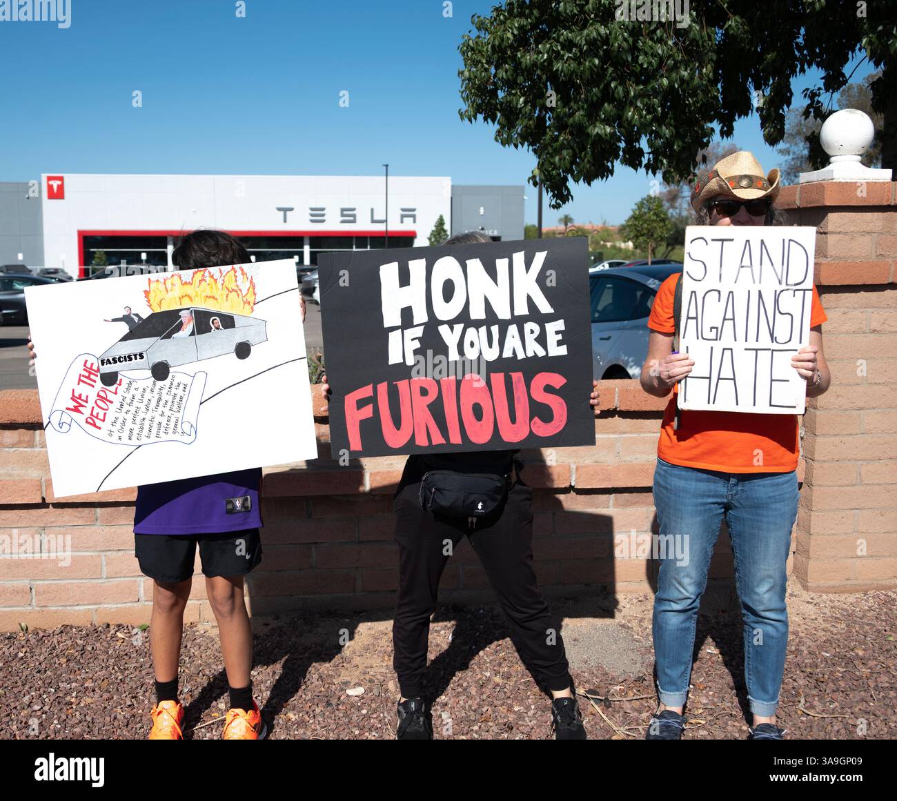 Protesters with placards deriding Elon Musk and Trump Administration's ...