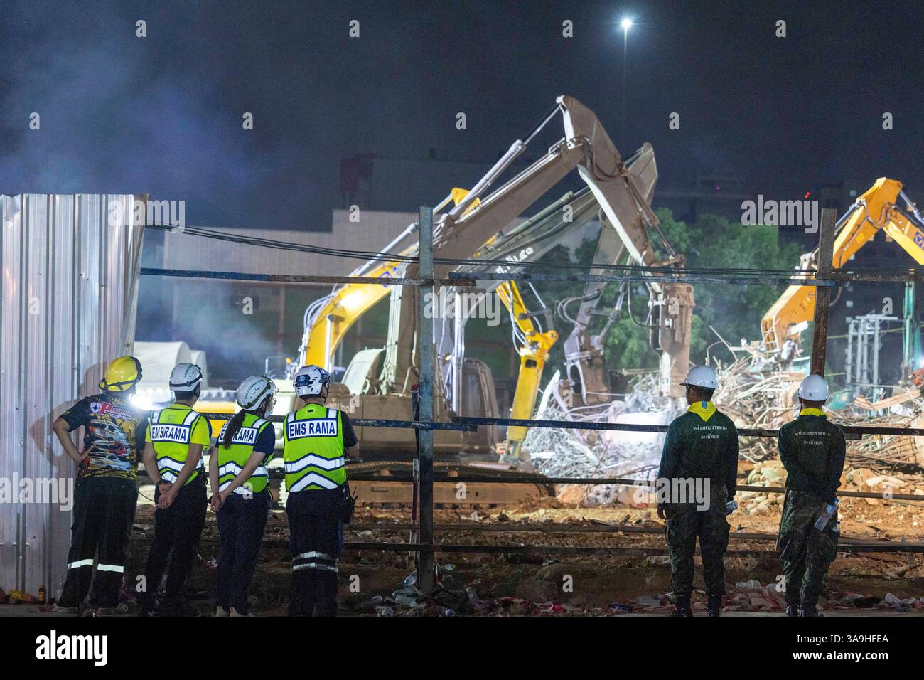 Rescuers work at the site of an under-construction high-rise building ...