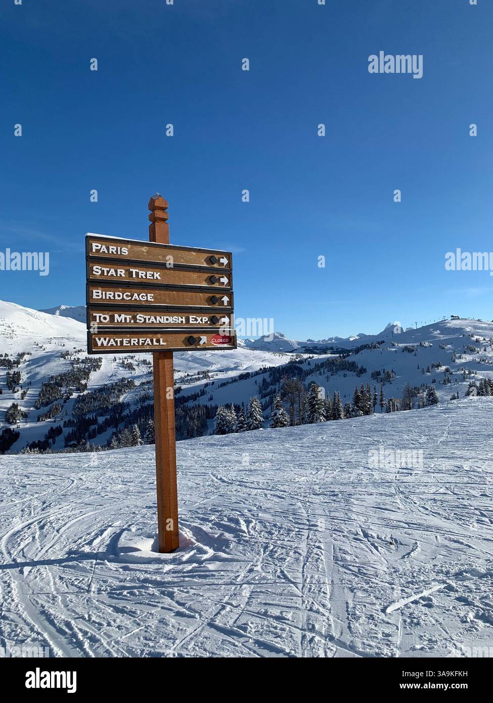 Ski trail signpost in a stunning snowy mountain landscape, guiding adventurers on the slopes. - Smartphone Captured Stock Image