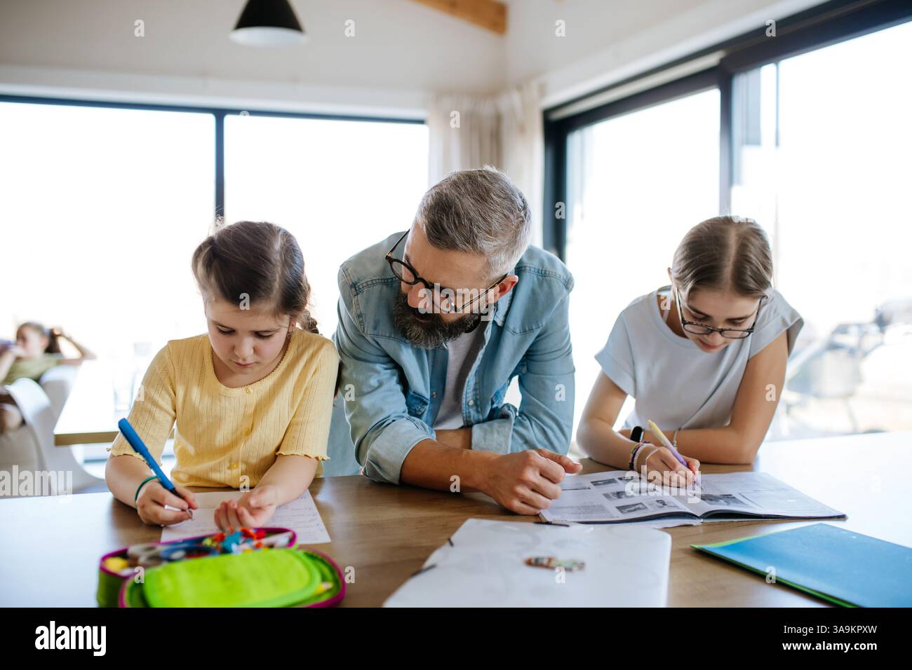Father helping his daughters with homework Stock Photo - Alamy