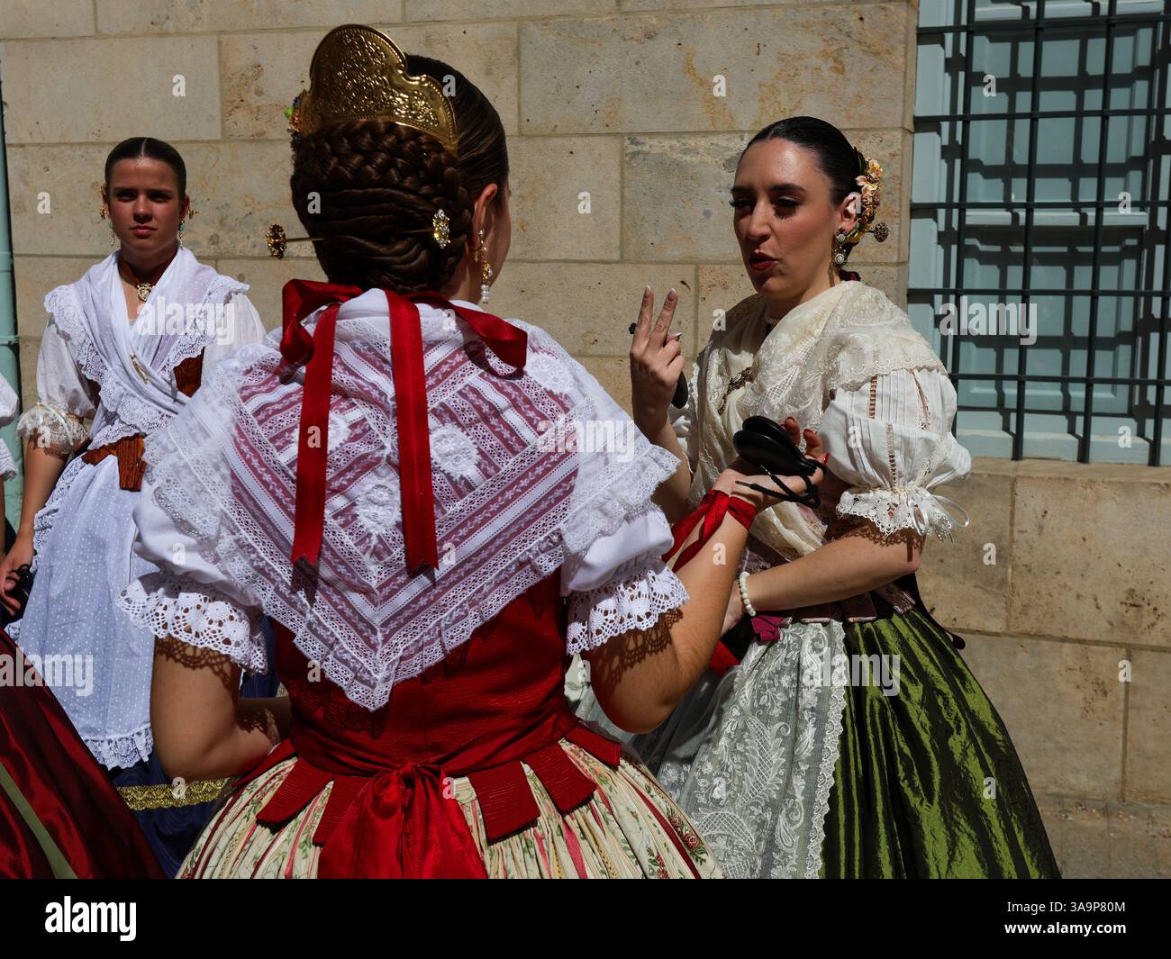 Women dressed in the traditional Fallera attire, also known as the ...