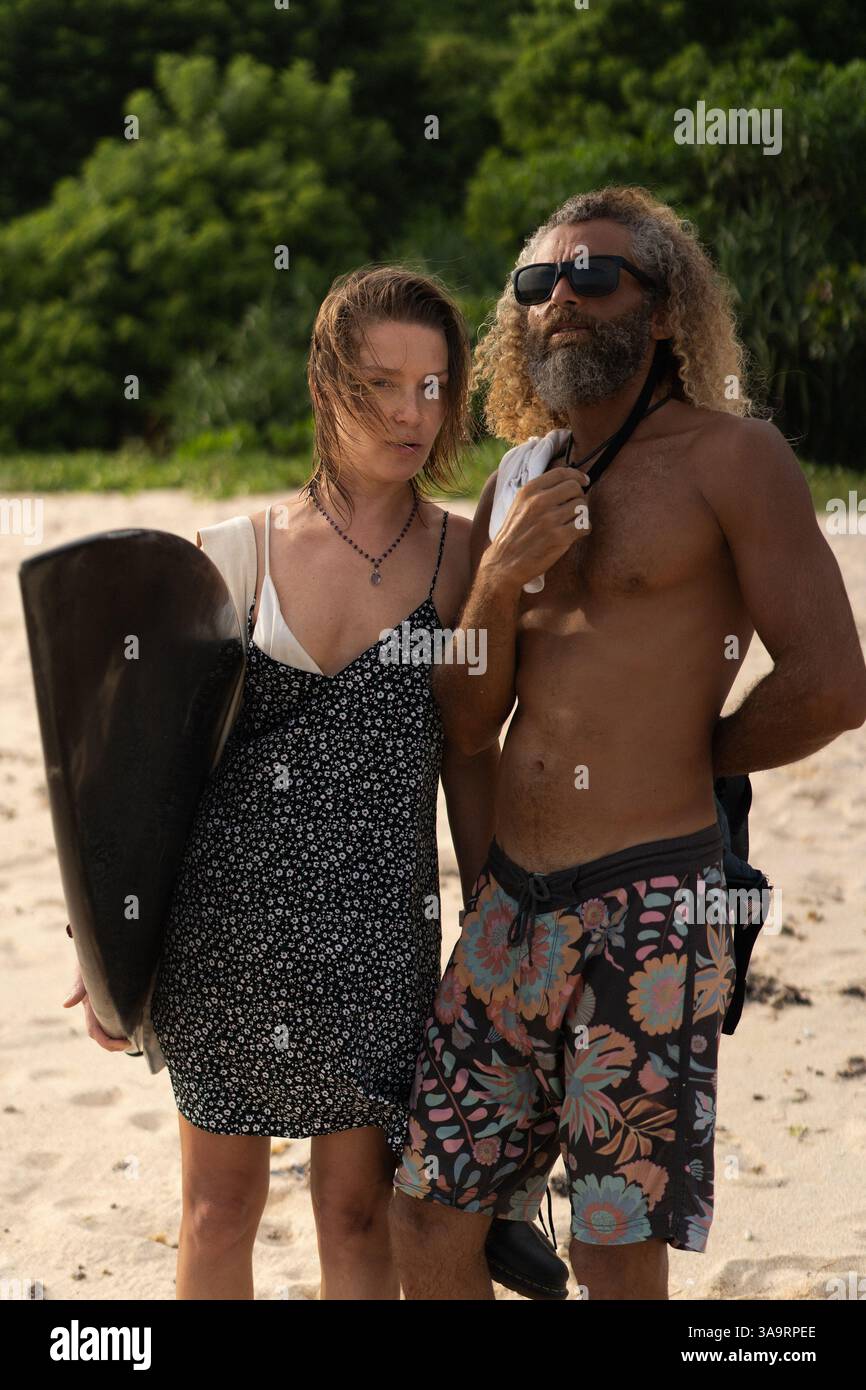 Friends with surfboard standing at beach Stock Photo