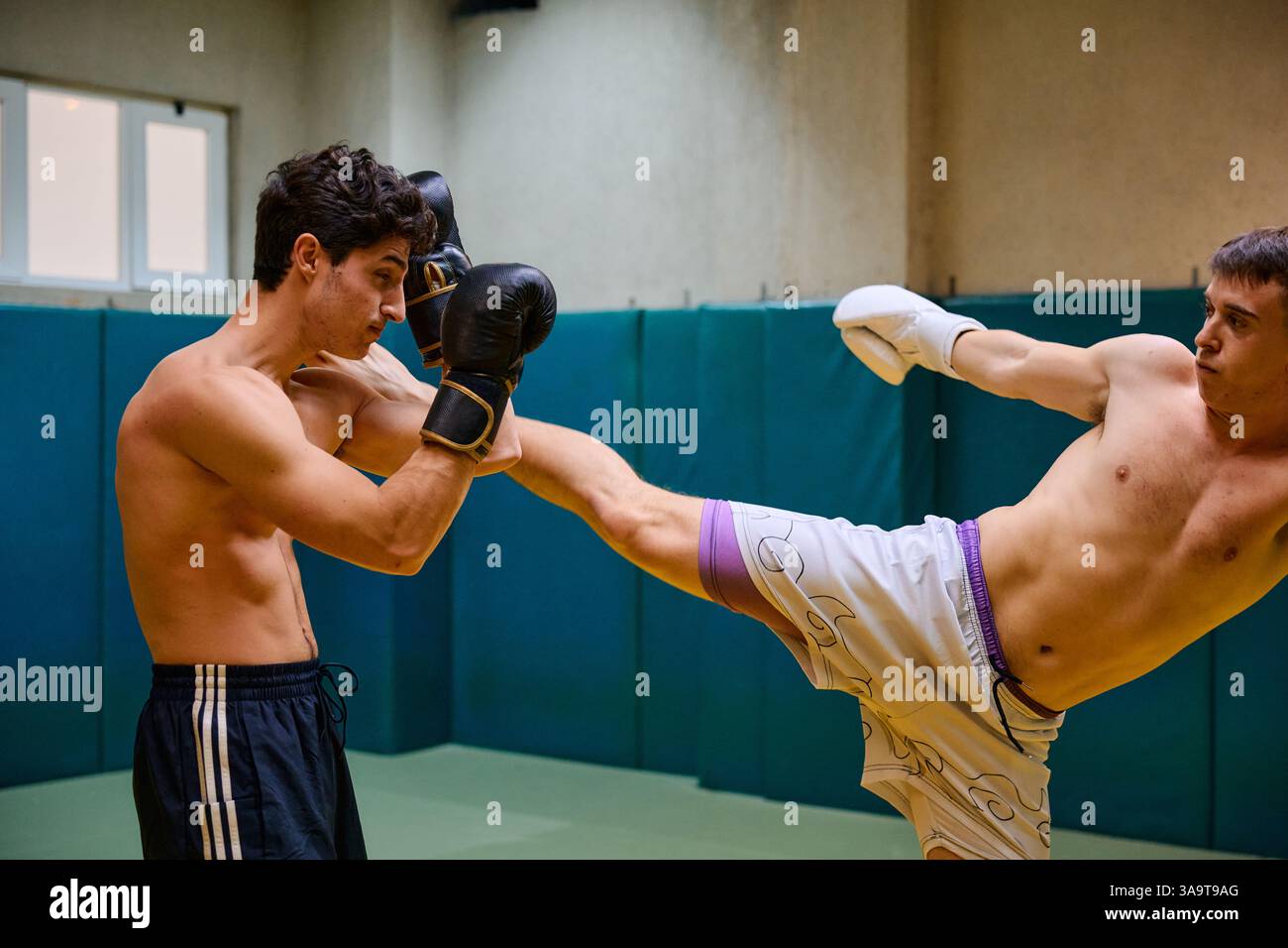 Training session in a martial arts gym with sparring athletes Stock Photo