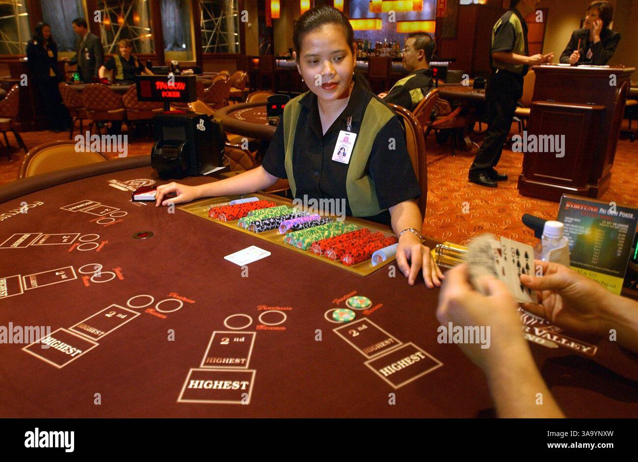 Fortune Pai Gow poker dealer Misty Nguyen (cq) waits for a player as he looks over his hand during a game at the Thunder Valley Casino Saturday, August 23, 2003. Local Indian casinos rely on the Asian American community for a big part of their business. Pai Gow is a popular game among the Asian American community. The Sacramento Bee /  Randy Pench  /ZUMA Press Stock Photo