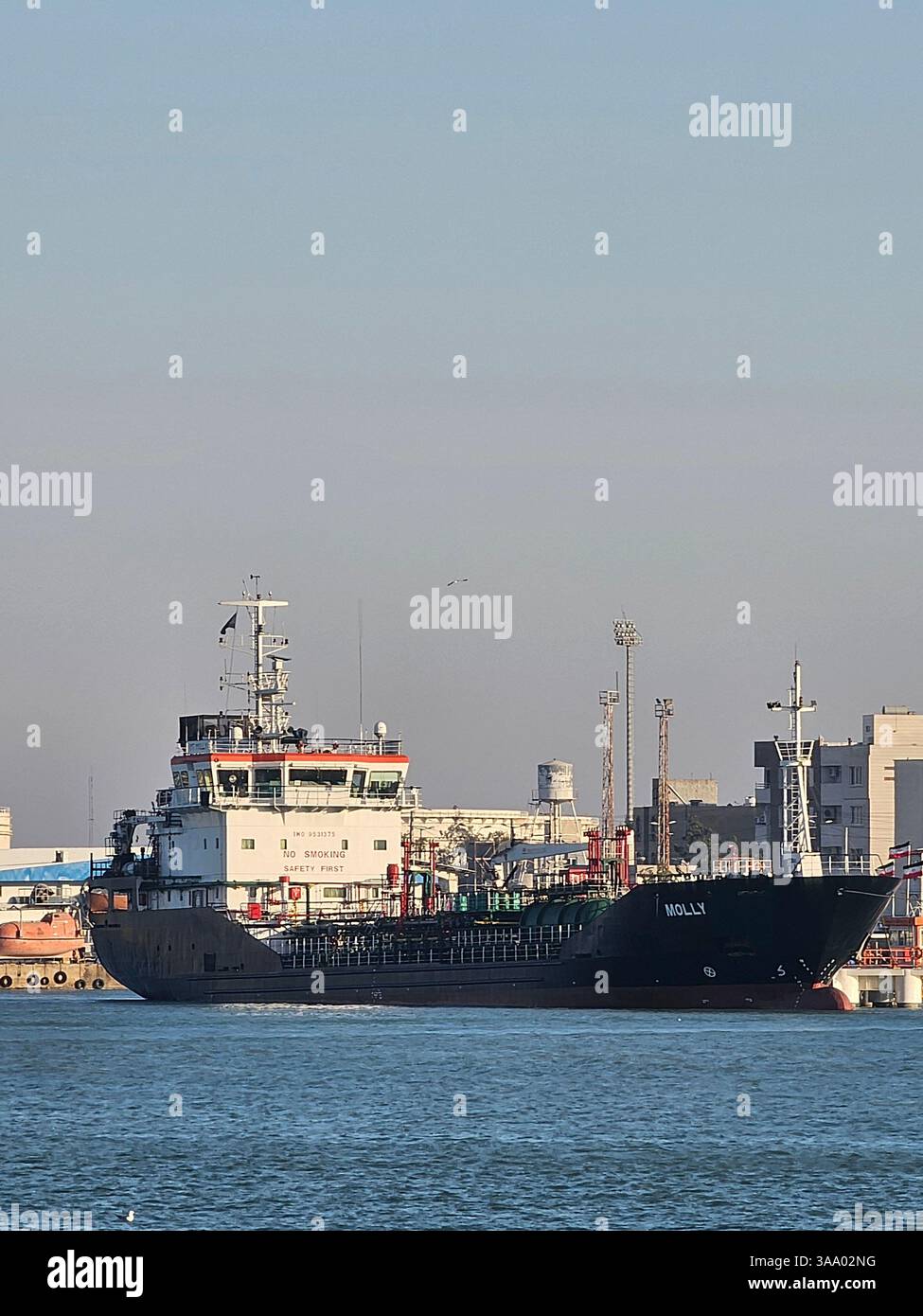 Option 1 (Focus on Detail): A detailed view of a boat's hull, showcasing its vibrant blue and red paint, along with essential nautical equipment like - Smartphone Captured Stock Image