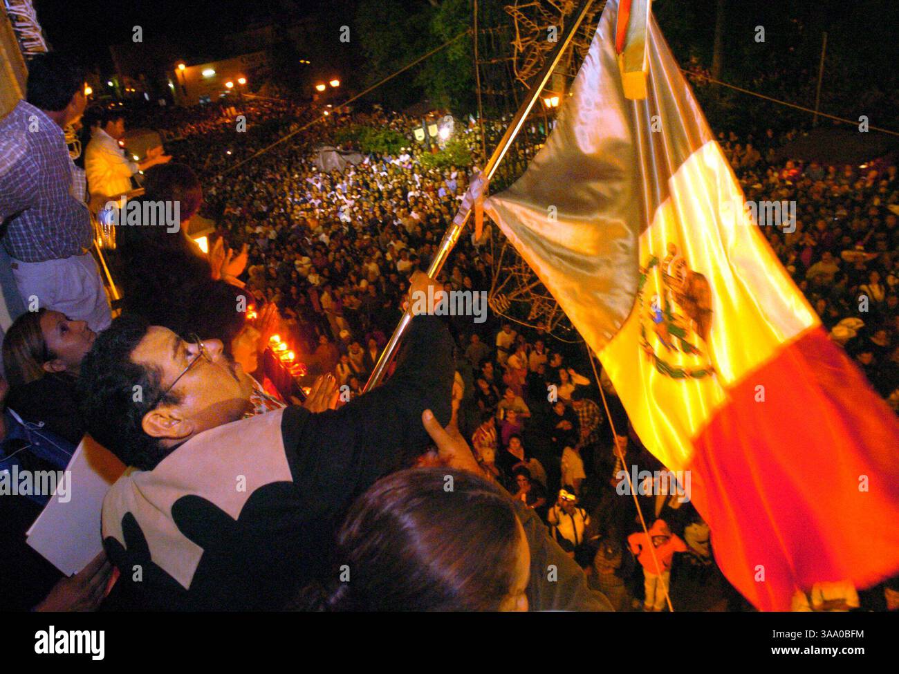ANDRES BERMUDEZ --  Andres Bermúdez, a dual citizen and recently of Winters, waves the Mexican flag after the traditional ''Grito de Independencia'' on September 15, 2004, from the balcony of his city hall office in Jerez, Zacatecas. Three years ago Bermúdez, was elected mayor of the town but was denied the office because he didn't meet the residency requirement. Since then Bermúdez helped write legislation in the Mexican government that would allow him and other migrants to hold office in the state of Zacatecas, Mexico. ( The Sacramento Bee Hector Amezcua )/ZUMA Press Stock Photo