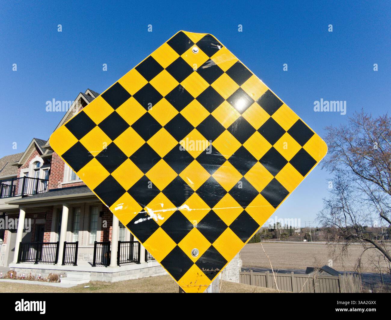 This boldly patterned checkerboard safety sign draws immediate ...