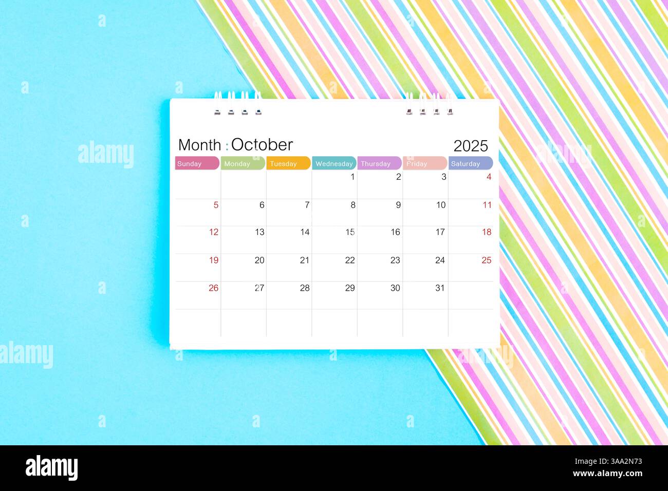October 2025 desk calendar on blue and rainbow color background Stock ...