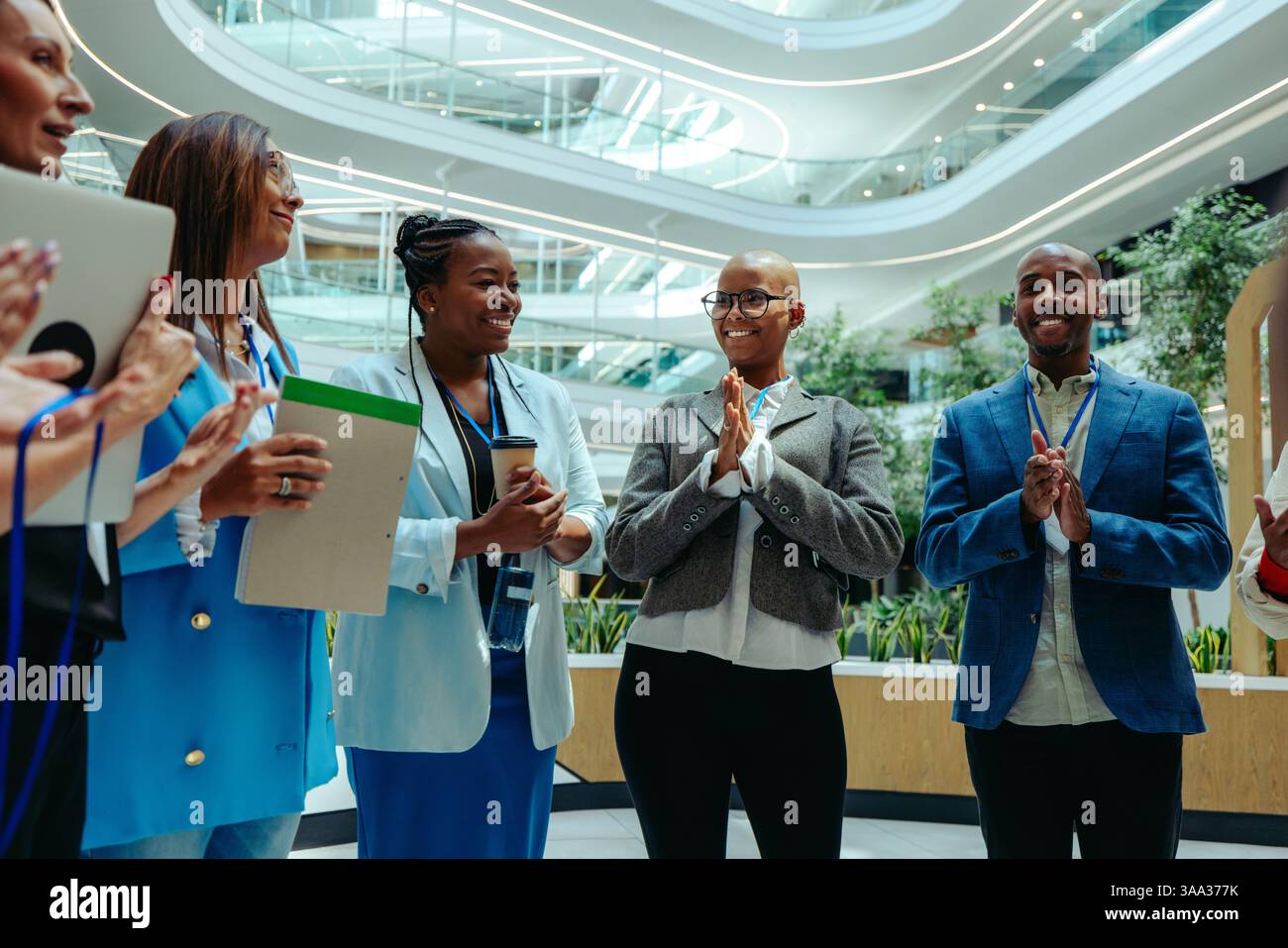 Group of diverse professionals in business attire having a discussion in a modern law firm office, showcasing teamwork and collaboration. Stock Photo