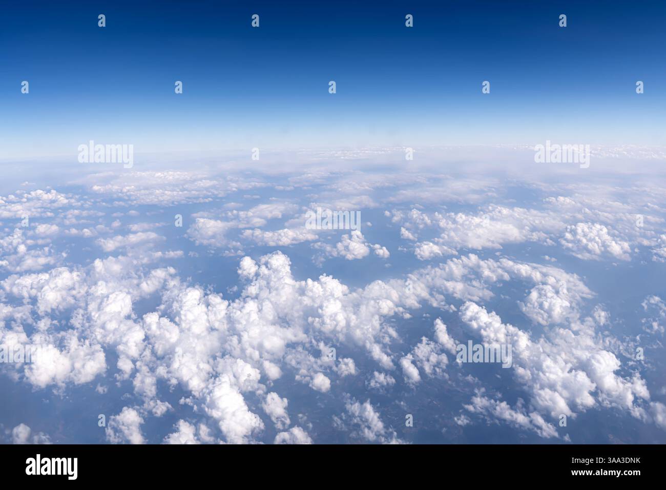 Background of white clouds against a blue sky. Stock Photo