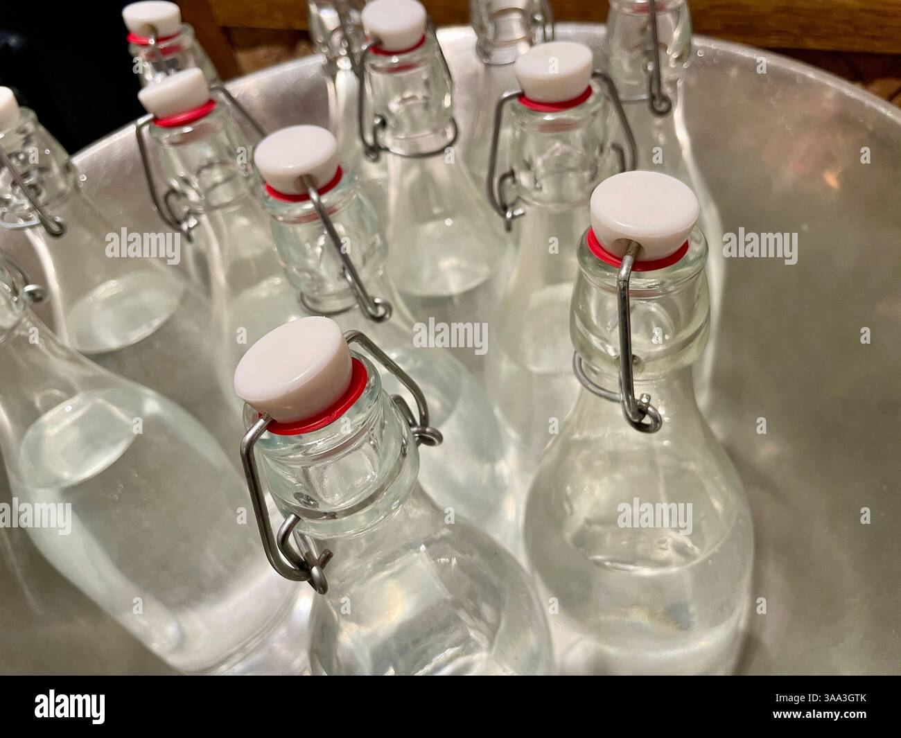 Close-up of an iced tub of clear glass flip-top water bottles at Eataly in the Flatiron District, 2025, New York City, USA - Smartphone Captured Stock Image
