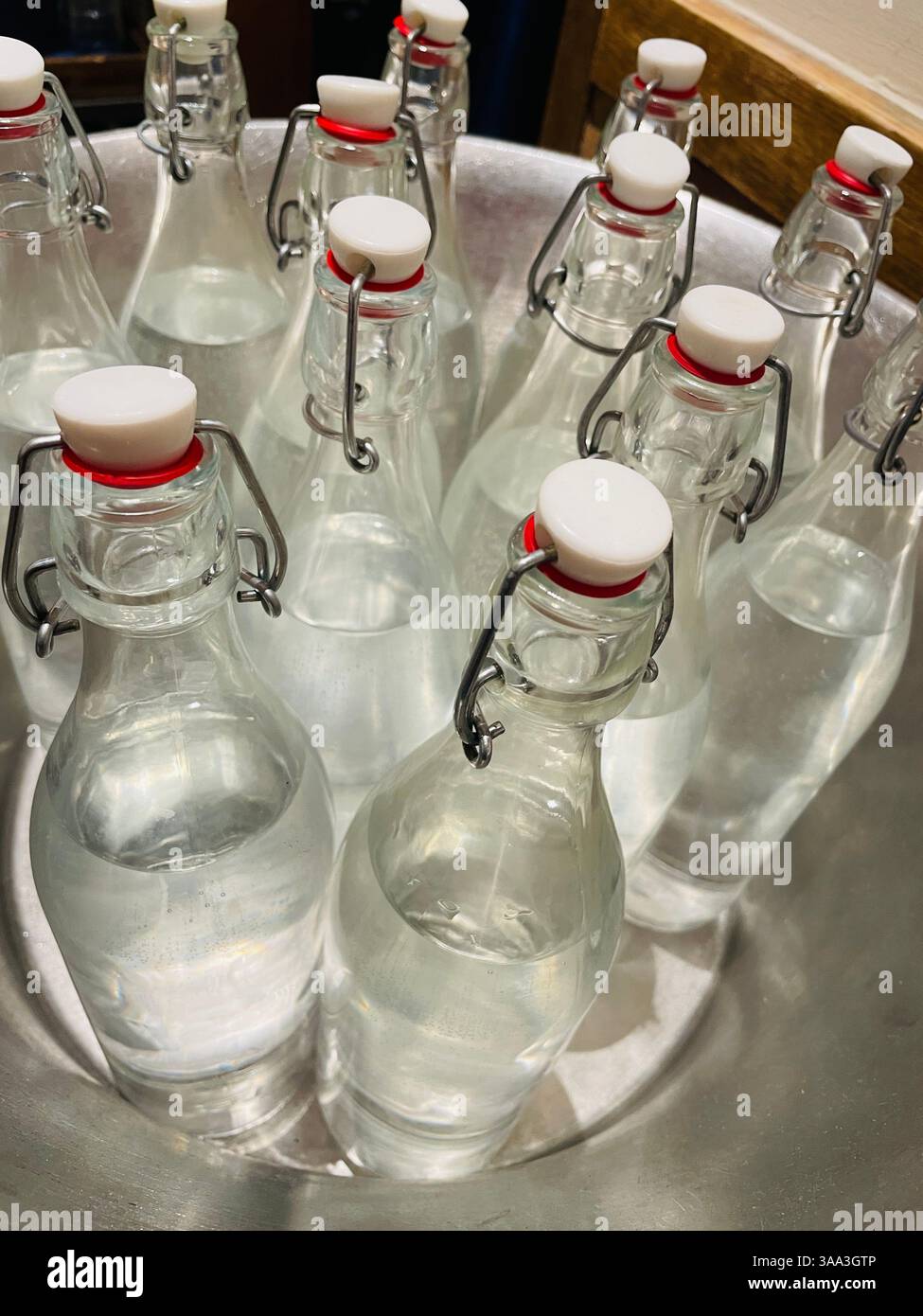 Close-up of an iced tub of clear glass flip-top water bottles at Eataly in the Flatiron District, 2025, New York City, USA - Smartphone Captured Stock Image