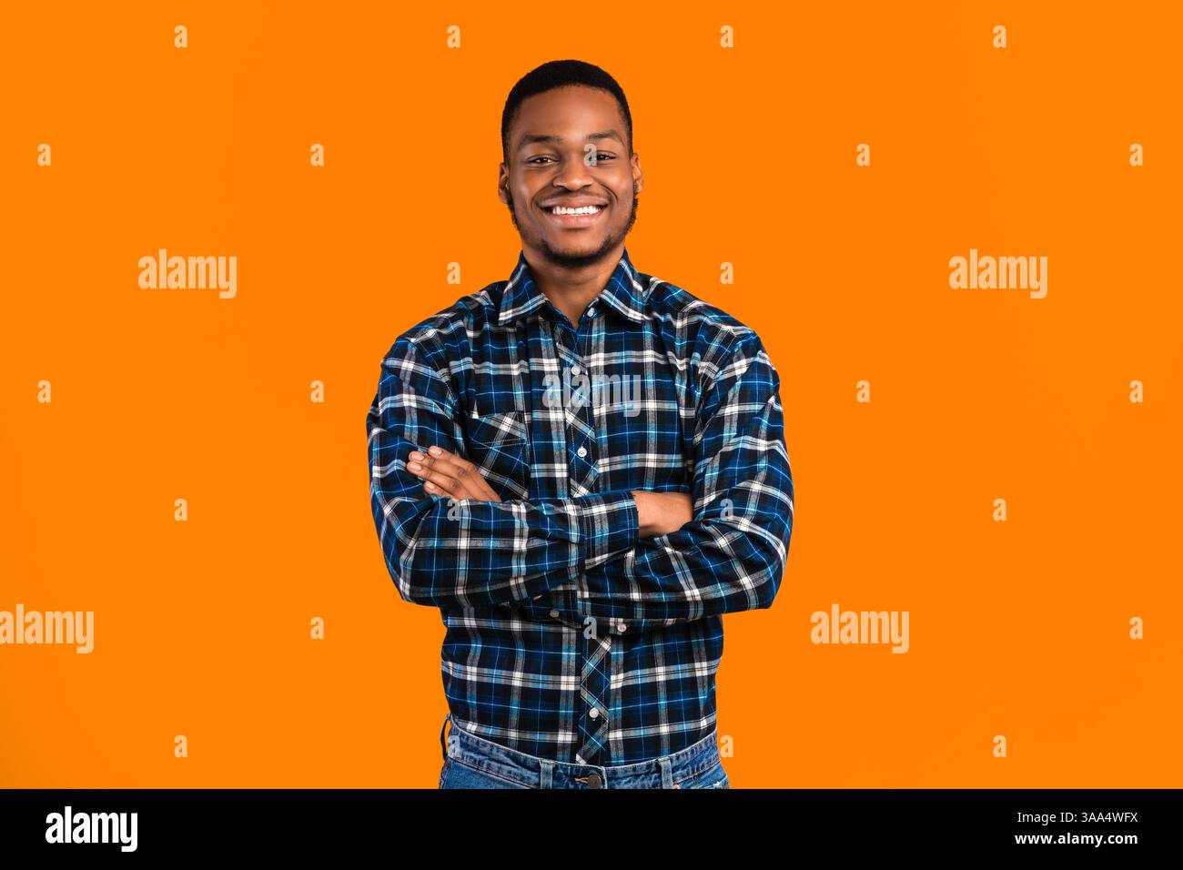 Black Man Posing Crossing Hands Standing In Studio Stock Photo