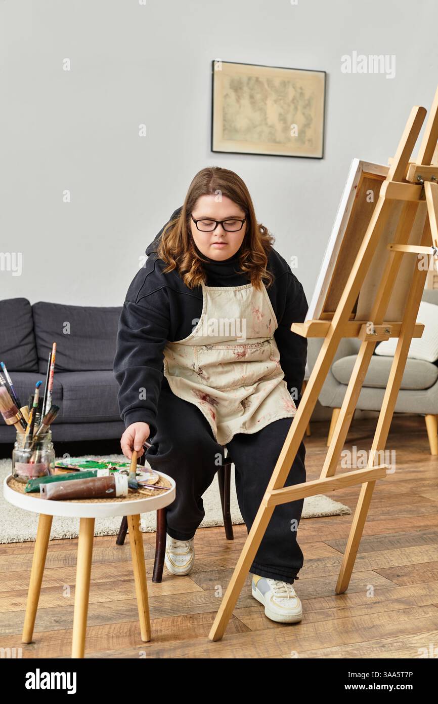 A Young Woman With Down Syndrome Creates Art In Her Home Studio Stock 