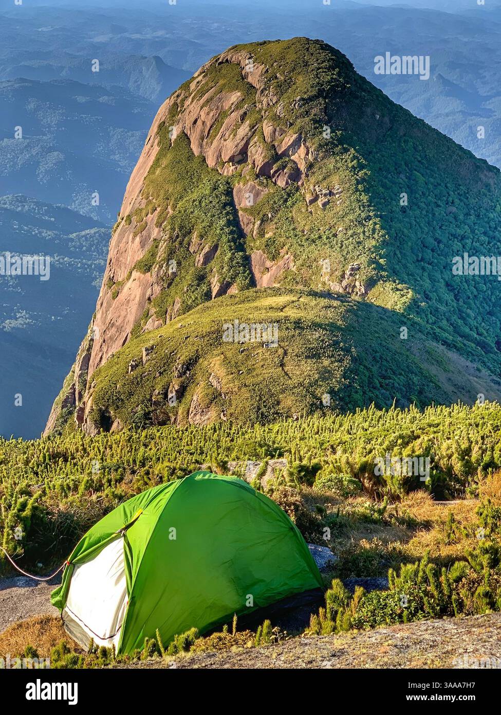 Stunning view from Pico Paraná, the highest peak in southern Brazil, with a small tent set against the backdrop of towering mountains and breathtaking - Smartphone Captured Stock Image