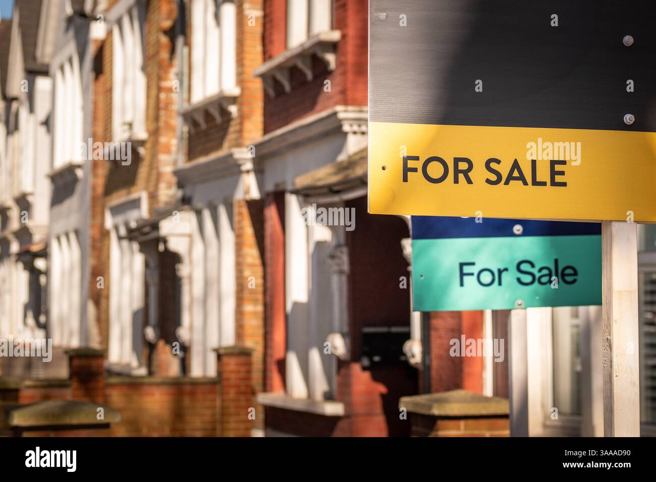 UK- London houses for sale advertised by estate agent signs Stock Photo