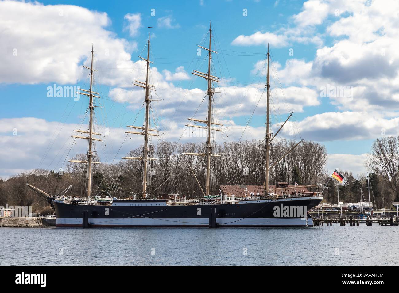 Baltic Sea in Germany a sailing ship is docked at the quay. Sails are lowered. Stock Photo