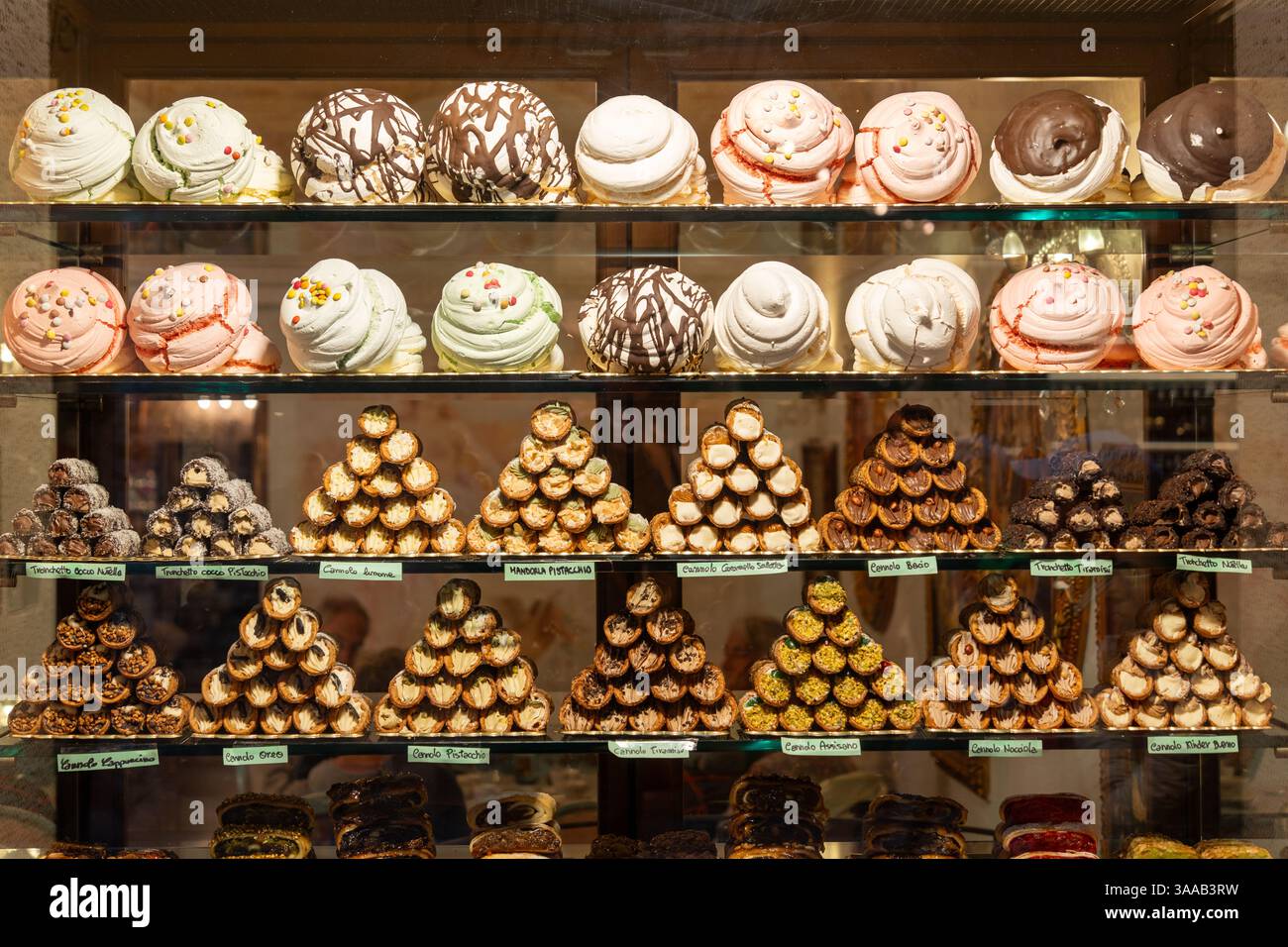 A display of many different types of pastries, including cupcakes and donuts. There are at least 15 different types of pastries on display Stock Photo