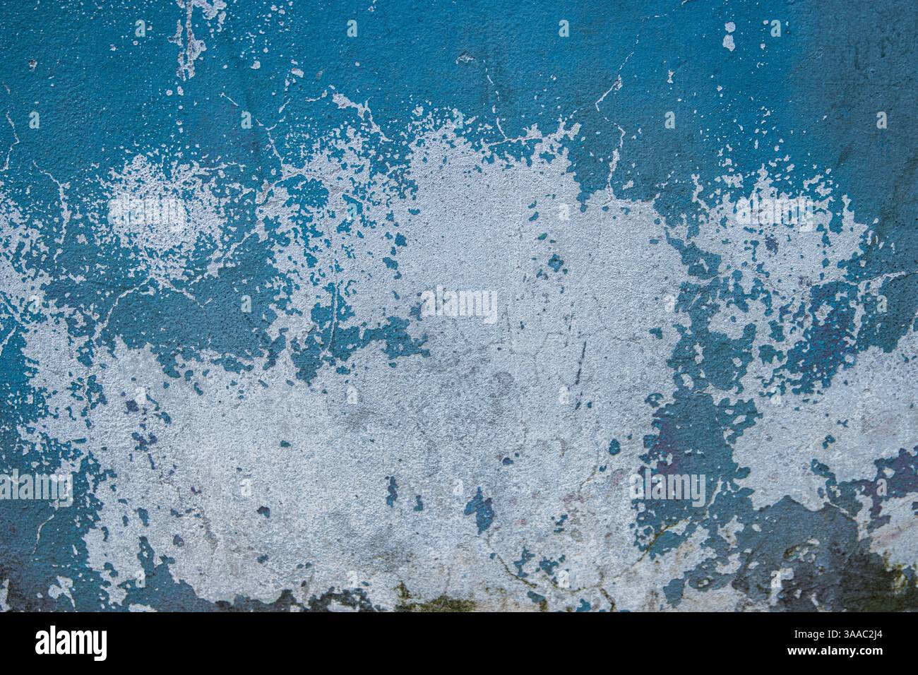 Peeling paint and cracked blue wall texture background. Weathered decayed urban surface with chipped paint and cracks. Distressed, rustic aesthetic fo Stock Photo