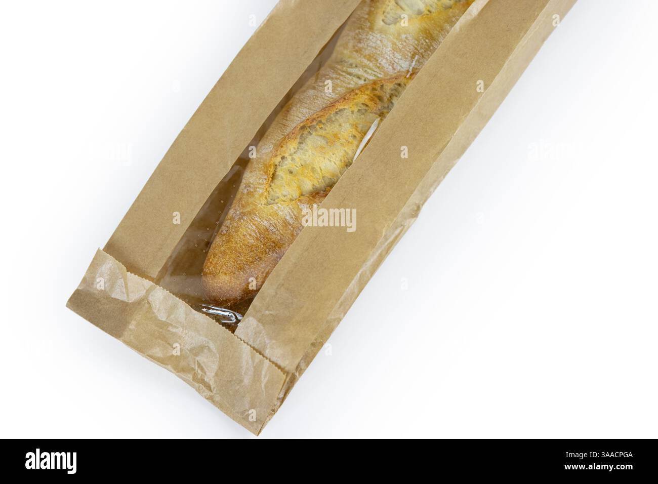 Freshly baked French baguette in a brown paper bag isolated on a white ...