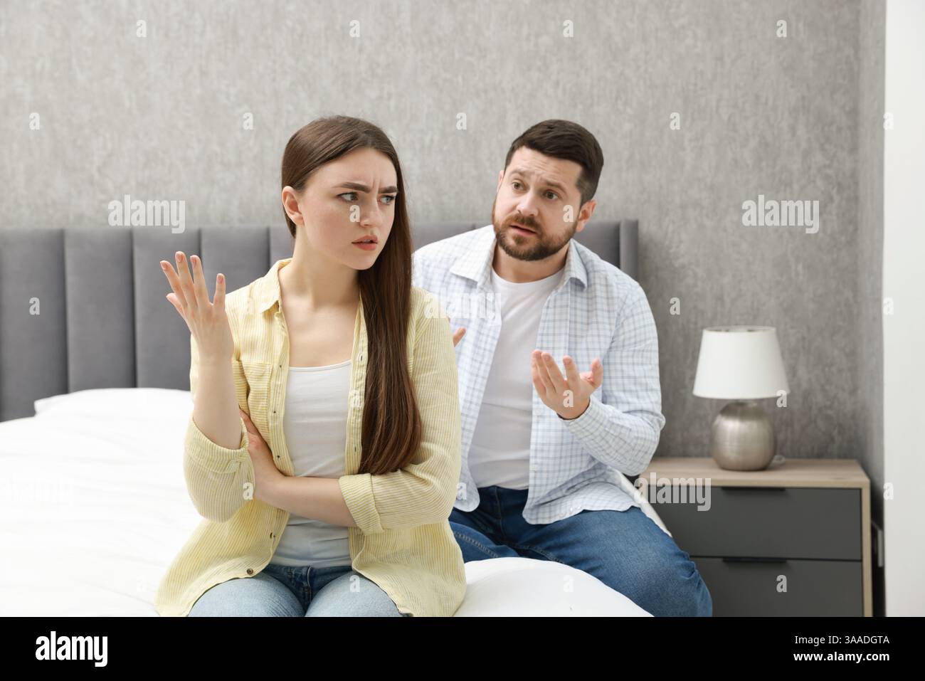 Angry couple arguing on bed at home Stock Photo - Alamy