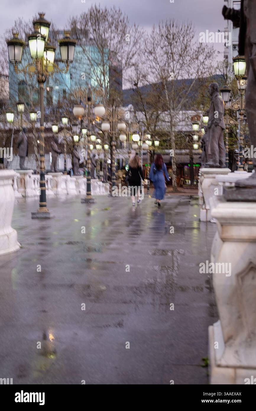 Rainy Evening Stroll in the City. Motion blur. Stock Photo