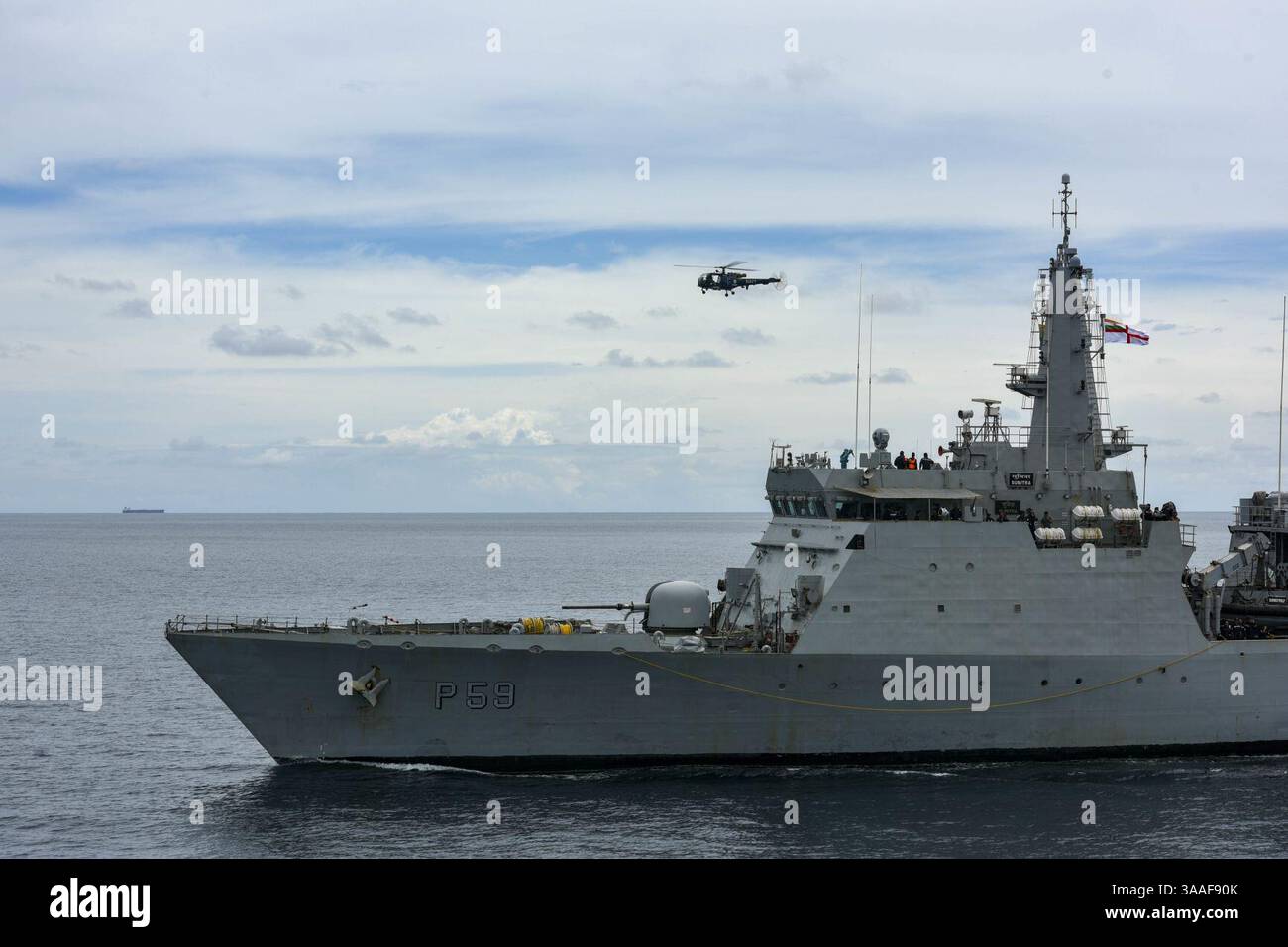 INS Sumitra (P59) with a Chetak helicopter during a passex with USS ...