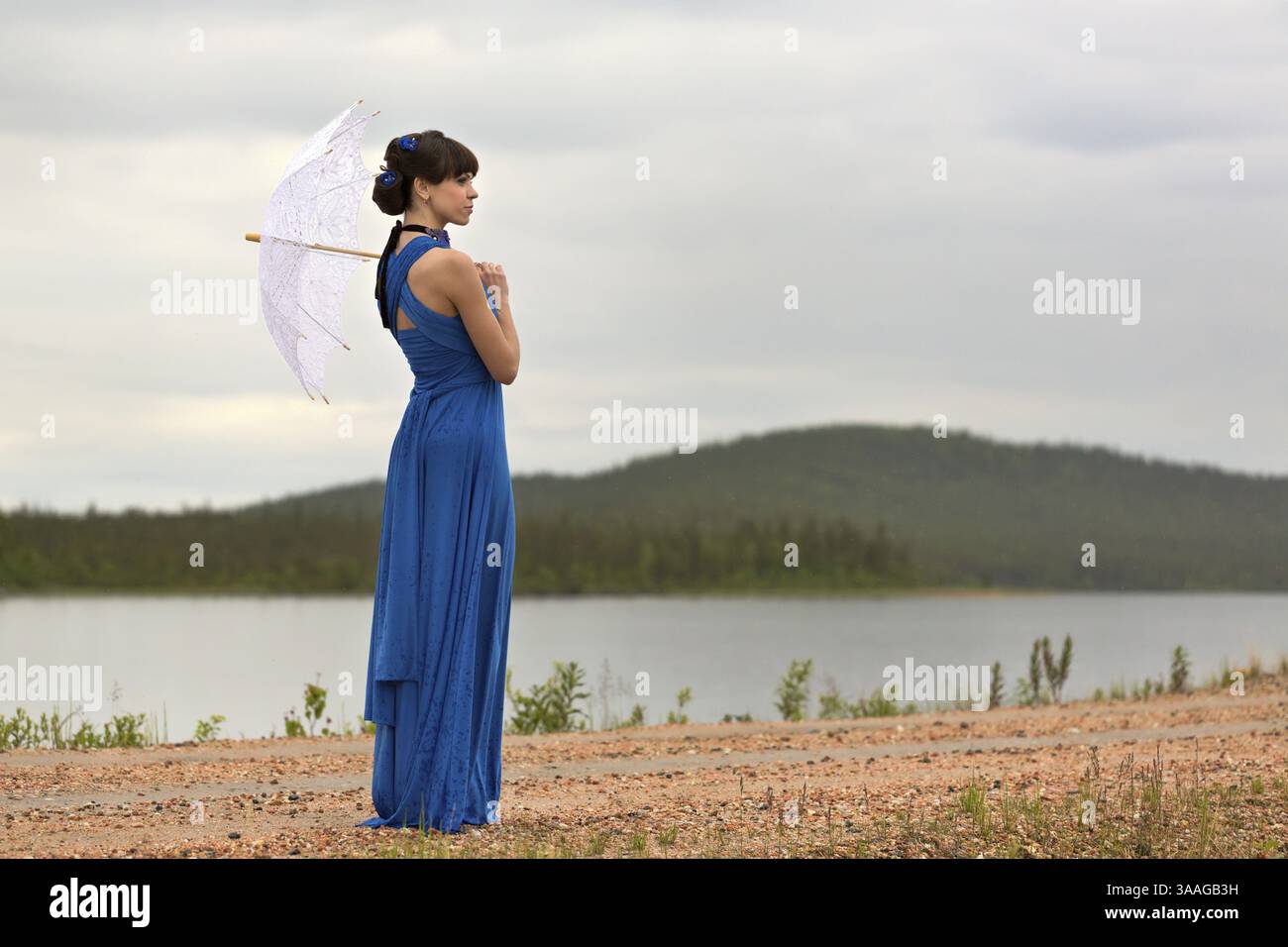 Beautiful dark haired model strolling through the woods. Fairy Tale setting Stock Photo