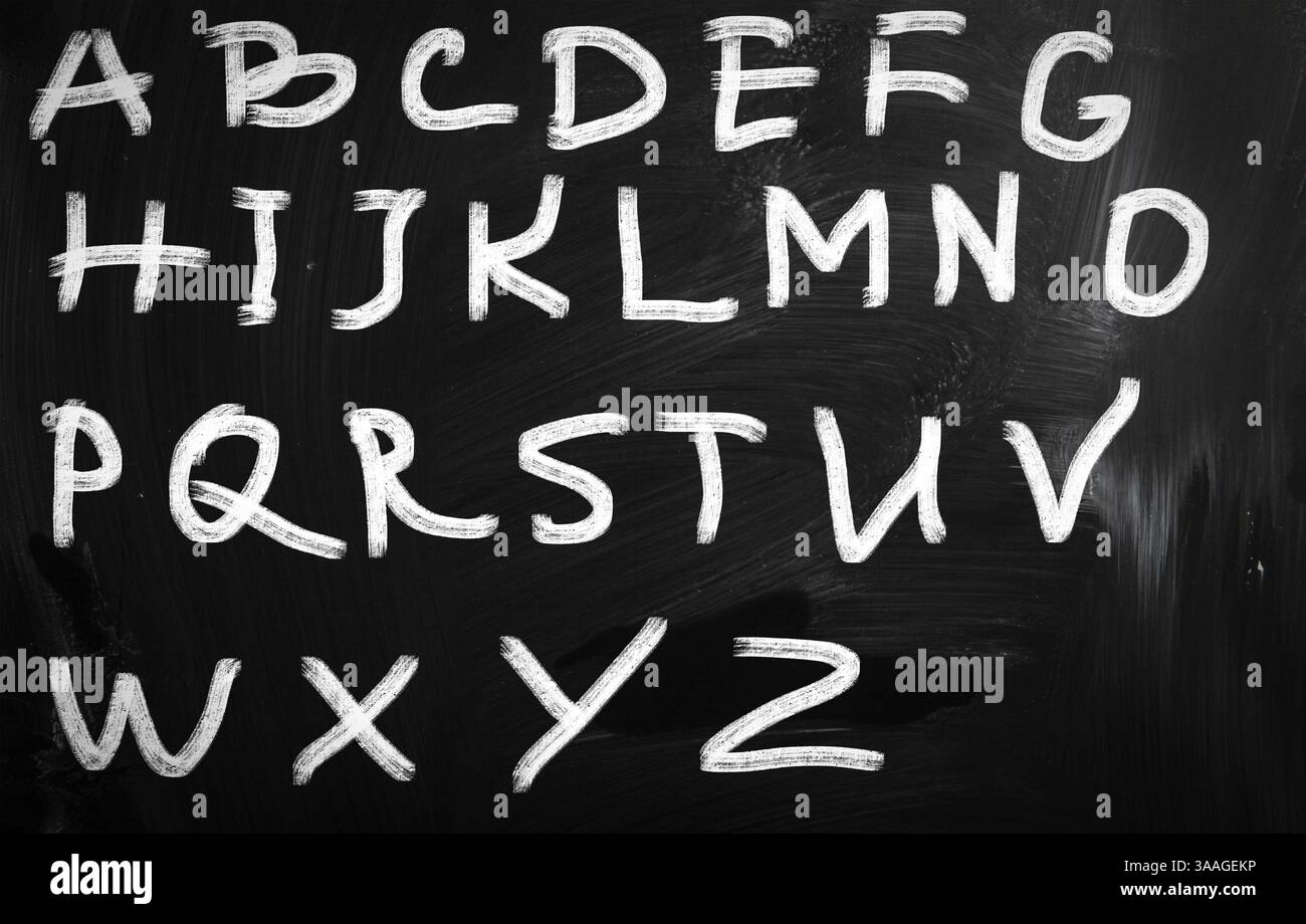 English alphabet handwritten with white chalk on a blackboard Stock Photo