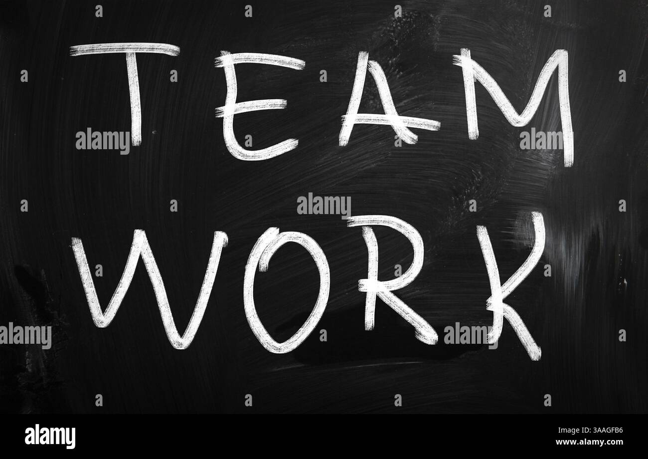 Teamwork handwritten with white chalk on a blackboard Stock Photo
