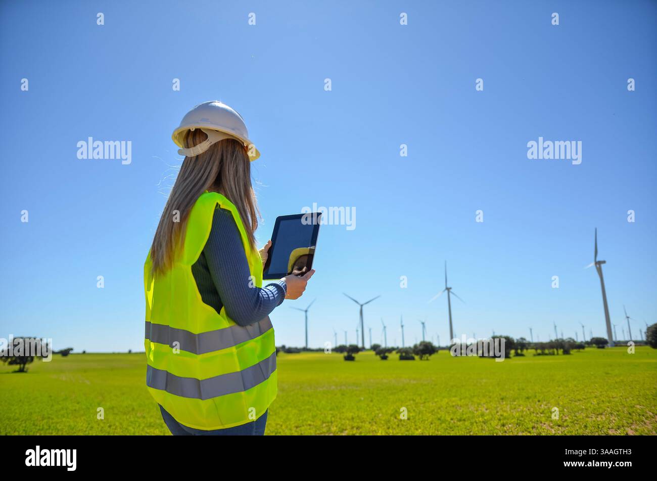 Engineer using tablet working in a wind turbine power plant checking data with digital tablet Stock Photo