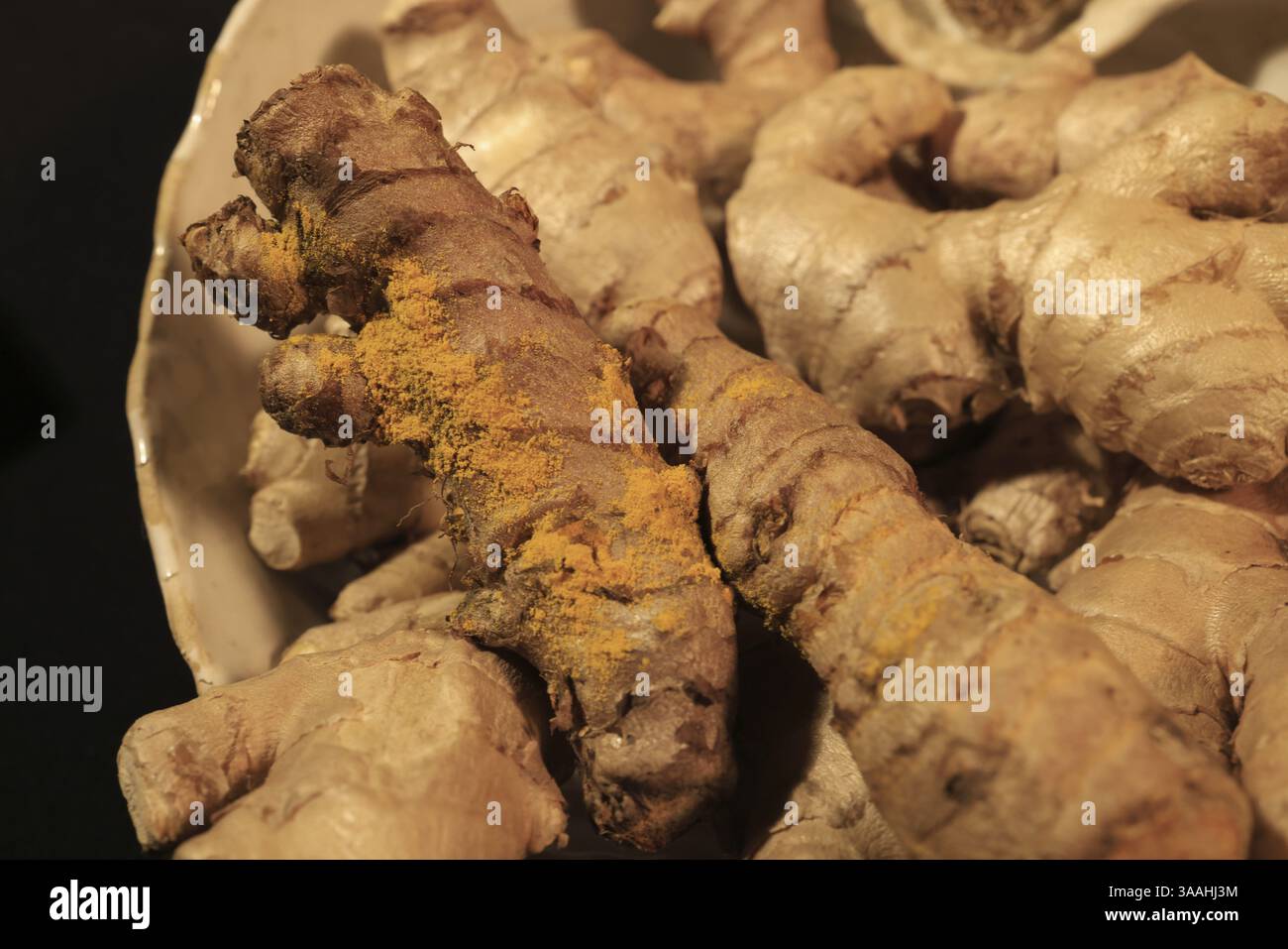 Ginger and Turmeric Roots on a dark background Stock Photo