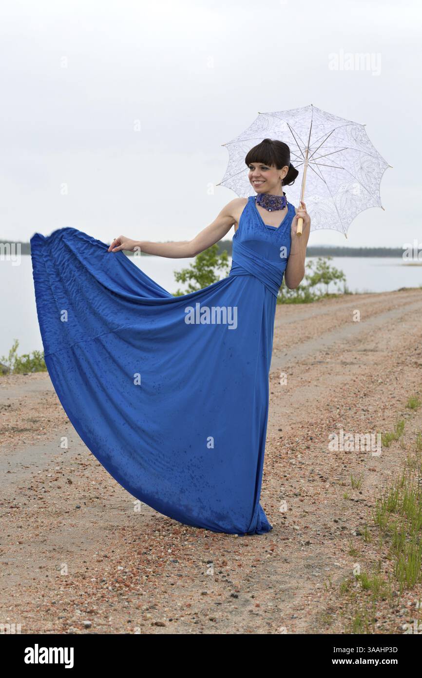 Beautiful dark haired model strolling through the woods Stock Photo