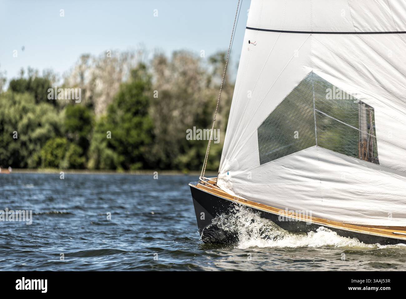 Classic sailing yacht sailing on a lake during a regatta Stock Photo ...