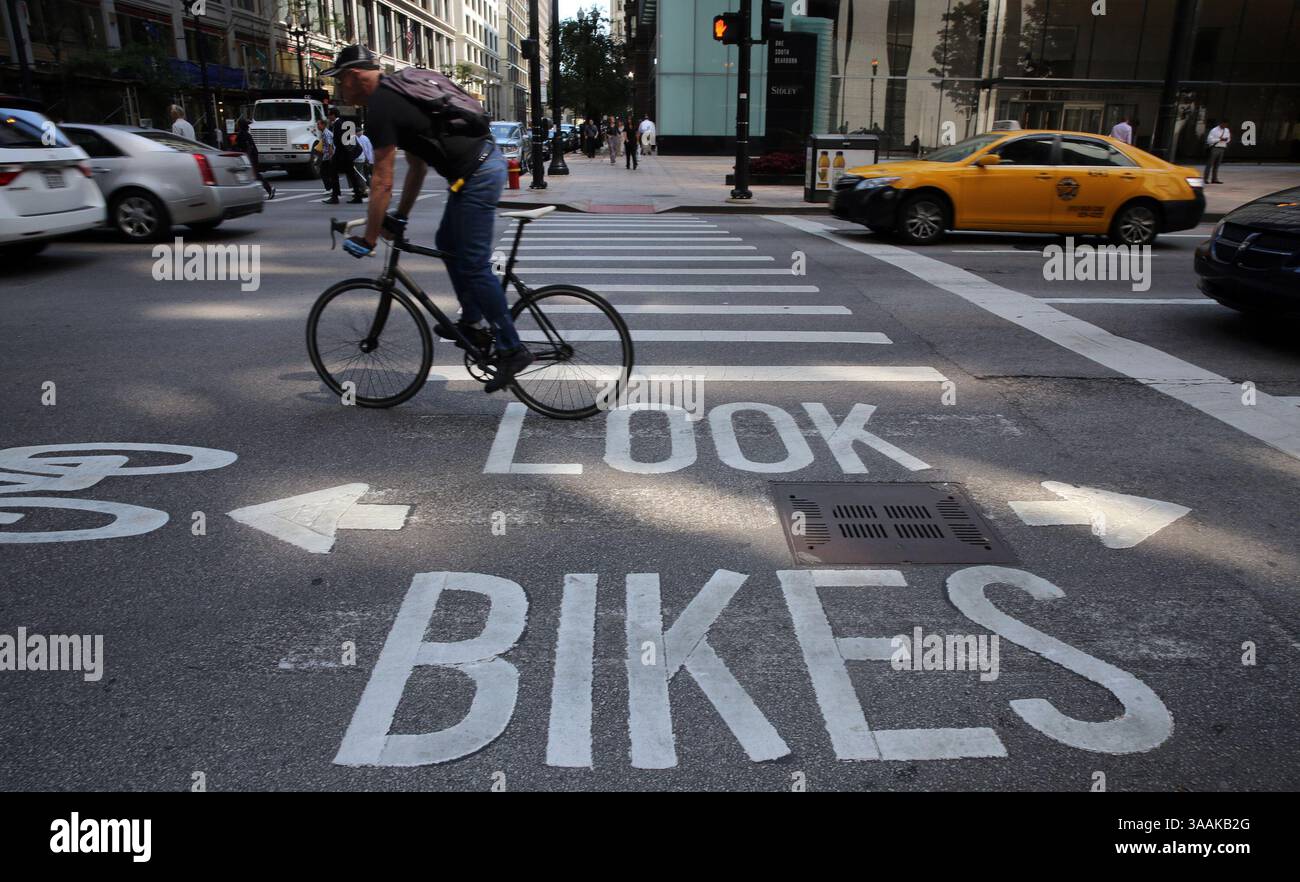 July 25, 2013 - Chicago, IL, USA - A bicyclist zooms past the ''look bikes'' signage at Dearborn and Madison in Chicago, Thursday, July 25, 2013. (Credit Image: © Antonio Perez/TNS via ZUMA Wire) Stock Photo