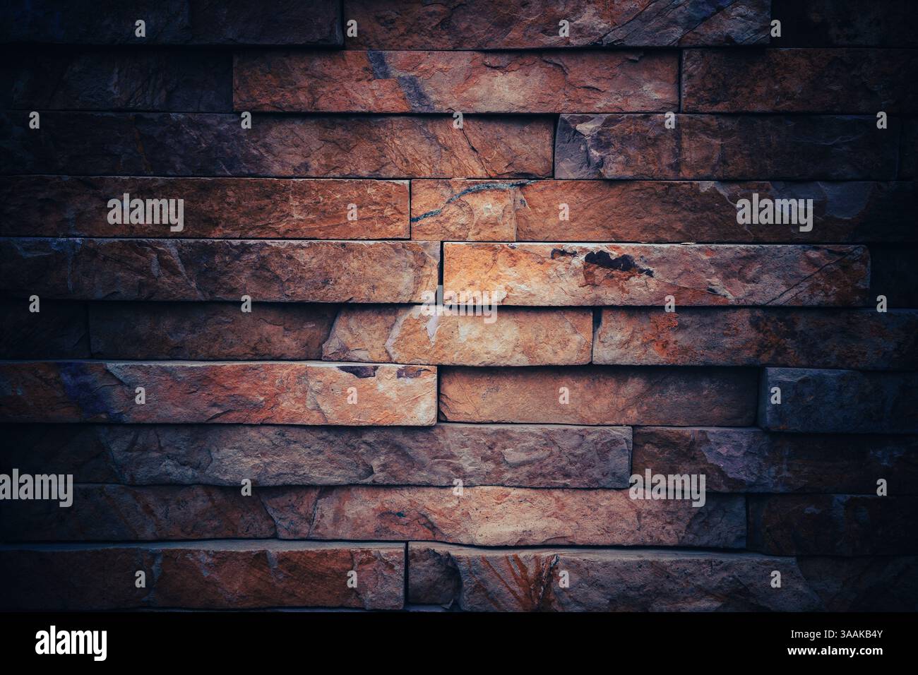 Interesting facade decorative bricks under dramatic lighting. Stock Photo
