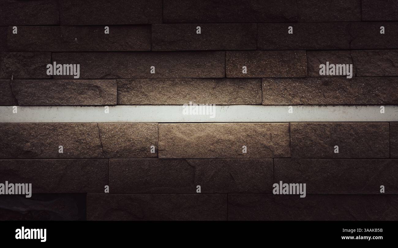 Interesting facade decorative bricks under dramatic lighting. Stock Photo