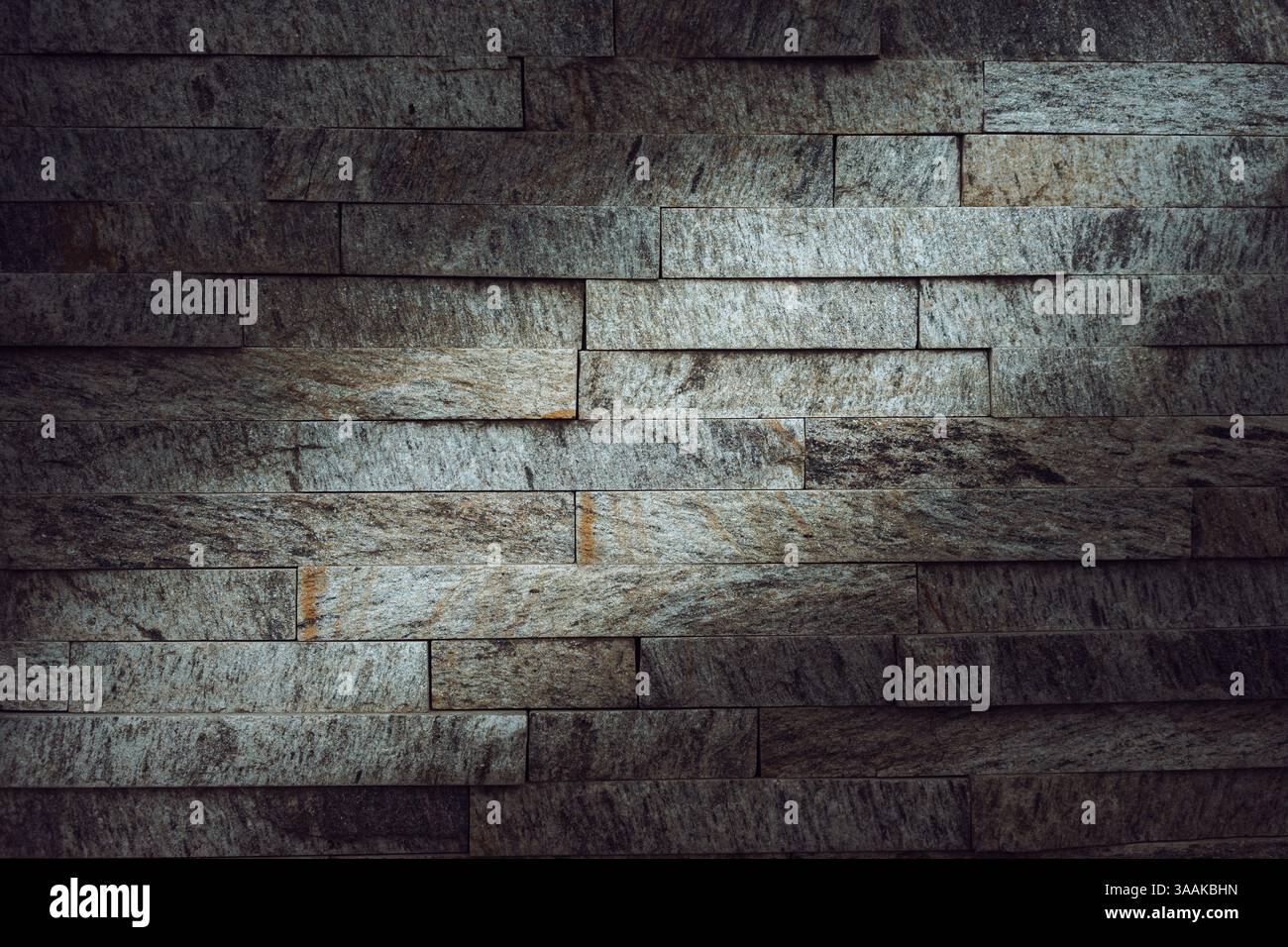 Interesting facade decorative bricks under dramatic lighting. Stock Photo