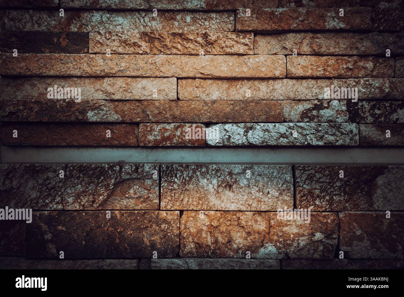 Interesting facade decorative bricks under dramatic lighting. Stock Photo